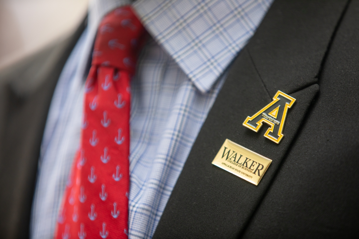 Closeup of App State and WCOB pins on suit