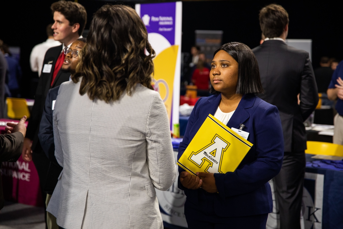 Student talking with employer at career fair