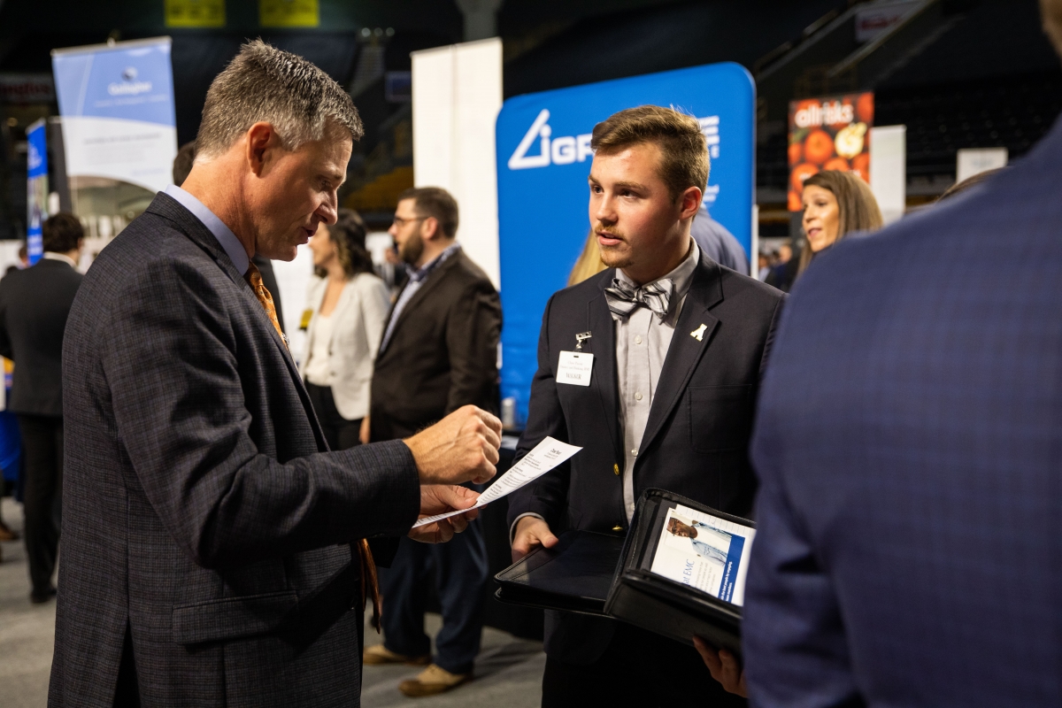 Student talking with employer at career fair